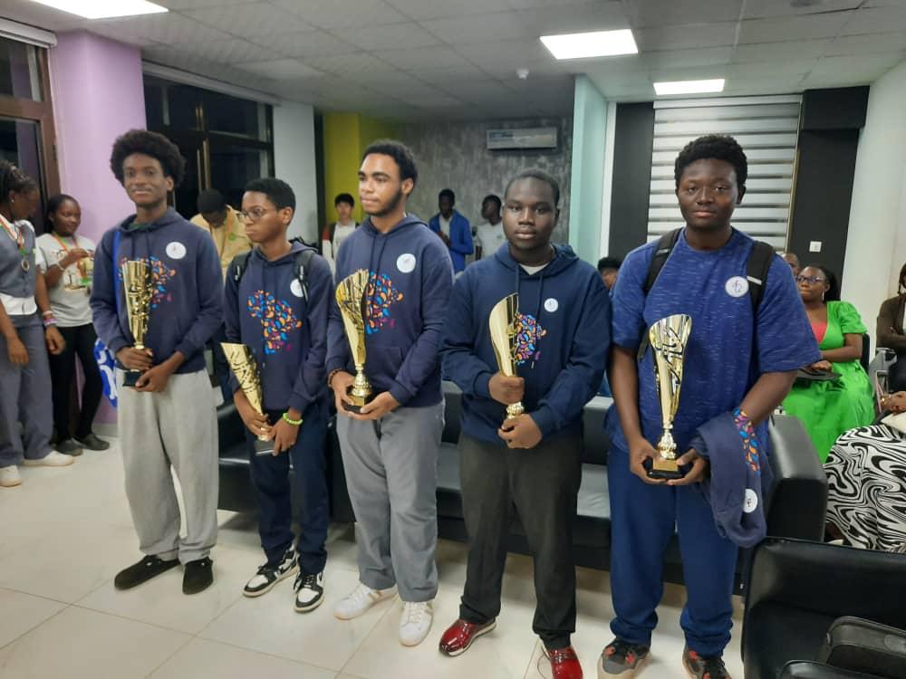 Rayann and his hackathon team holding first place trophies.